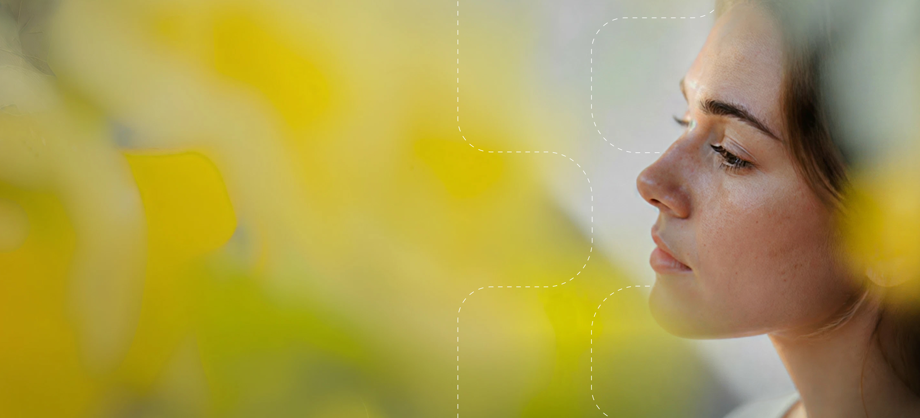 Close profile of a woman looking through soft yellow light